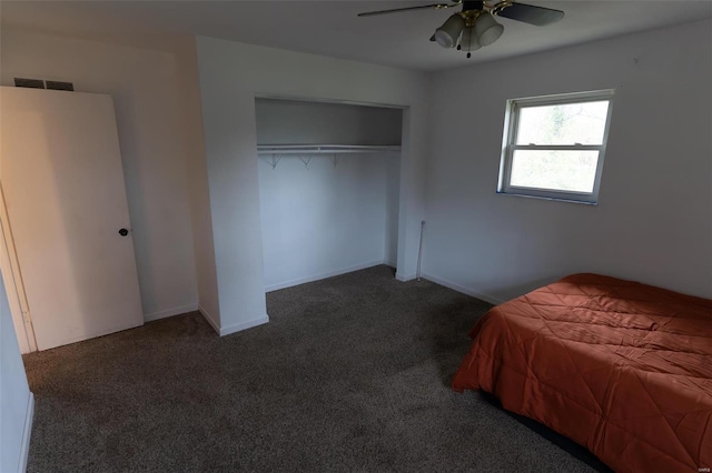 unfurnished bedroom featuring a closet, dark carpet, and ceiling fan