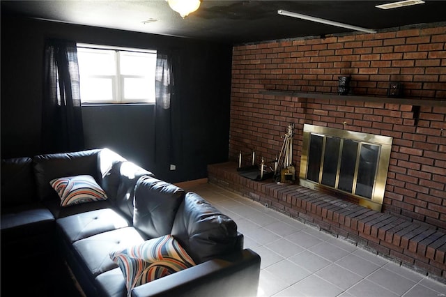 living room with light tile patterned floors, brick wall, and a brick fireplace