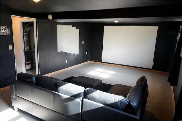 home theater featuring beam ceiling and tile patterned floors