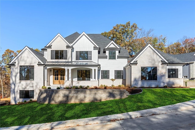 modern inspired farmhouse with covered porch and a front yard