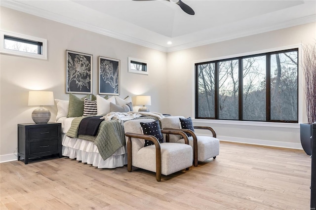 bedroom with multiple windows, ceiling fan, and light wood-type flooring