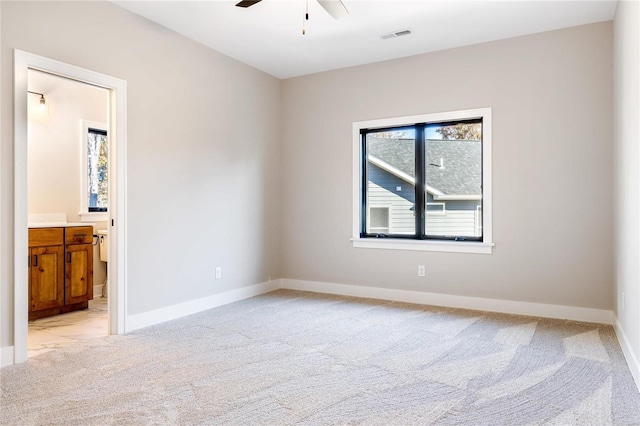 carpeted spare room with ceiling fan