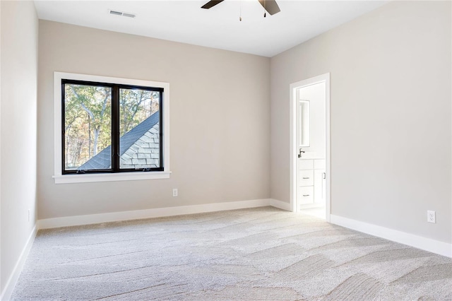 carpeted spare room with ceiling fan