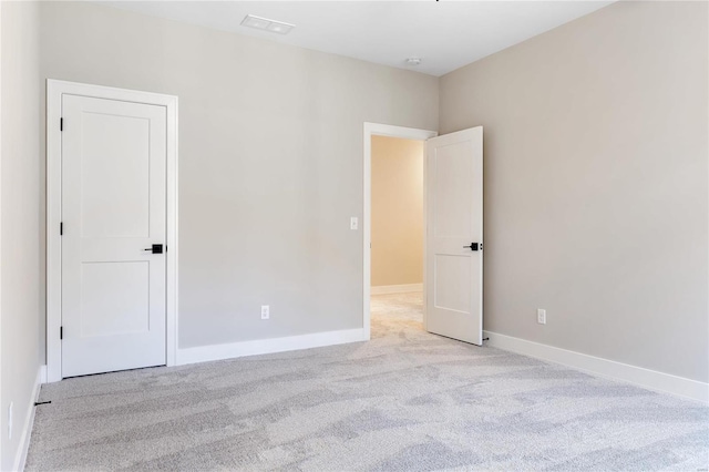 empty room featuring light colored carpet