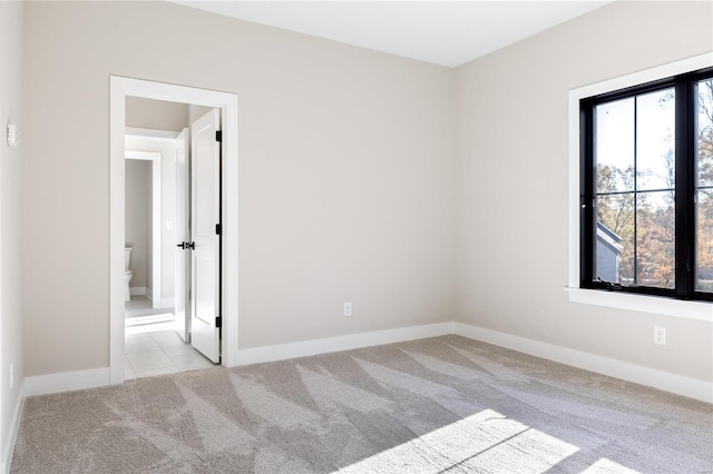 spare room with light colored carpet