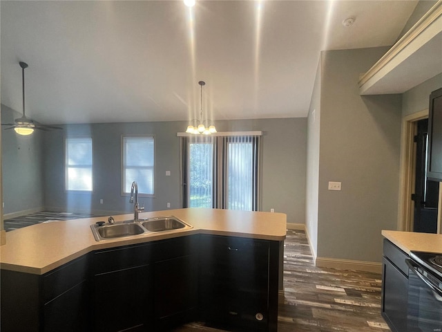 kitchen with vaulted ceiling, dark wood-type flooring, sink, pendant lighting, and black electric range oven