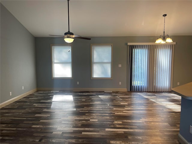 unfurnished room featuring vaulted ceiling, ceiling fan with notable chandelier, and dark wood-type flooring