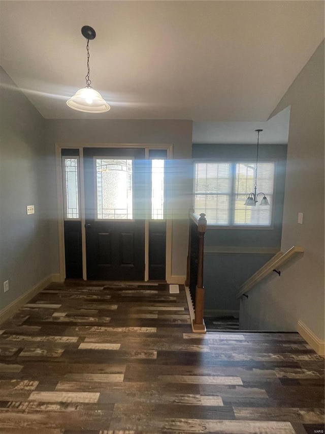 entryway featuring dark hardwood / wood-style floors and vaulted ceiling