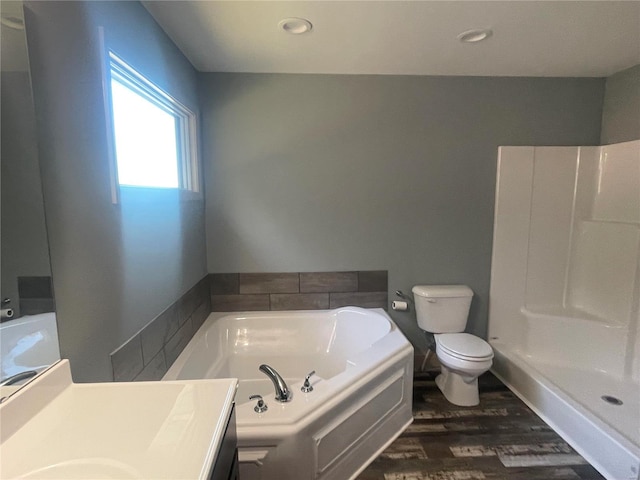 full bathroom with vanity, hardwood / wood-style floors, toilet, and shower with separate bathtub