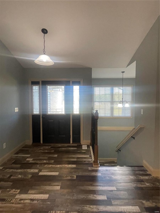 entrance foyer featuring dark wood-type flooring and lofted ceiling