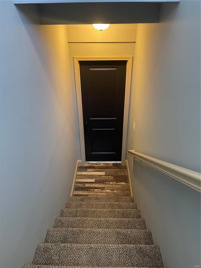 stairs with hardwood / wood-style floors