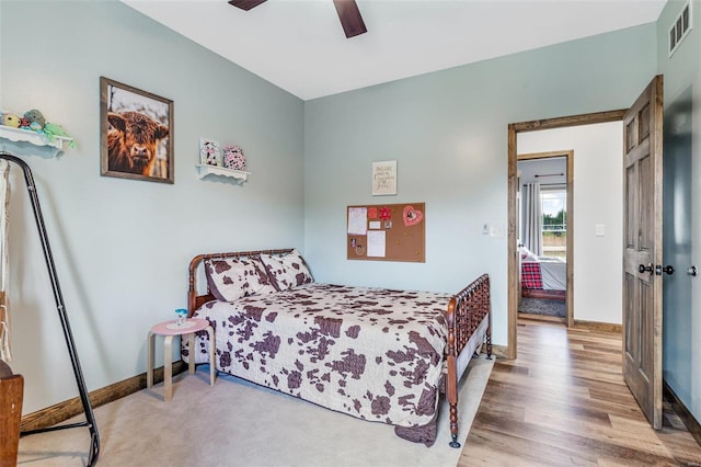 bedroom featuring light hardwood / wood-style floors and ceiling fan