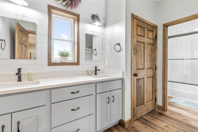 bathroom featuring vanity, hardwood / wood-style flooring, and shower / bathtub combination