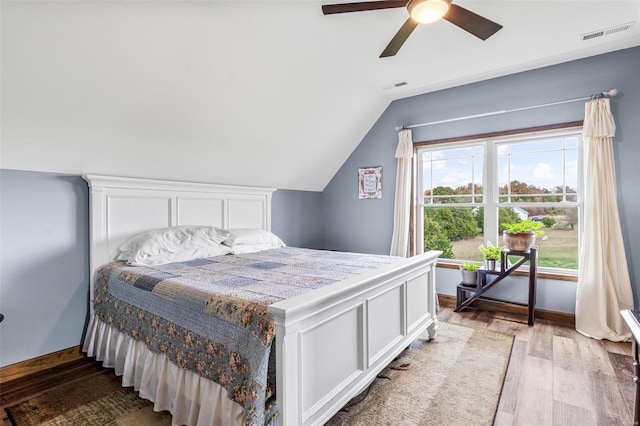 bedroom with light wood-type flooring, lofted ceiling, and ceiling fan