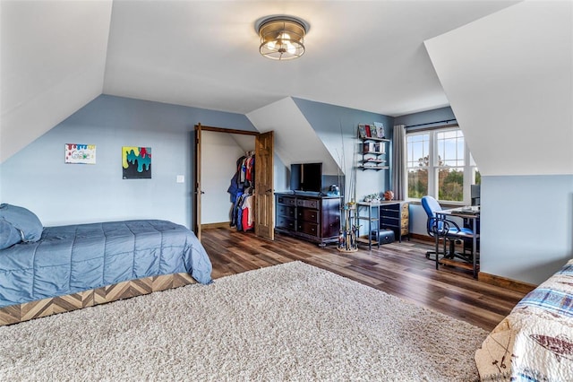 bedroom featuring dark hardwood / wood-style floors and vaulted ceiling