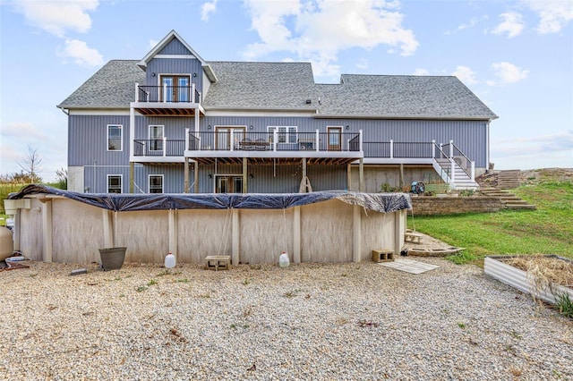 rear view of house featuring a pool side deck