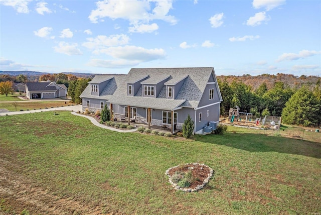 new england style home with central AC unit, a front lawn, and covered porch