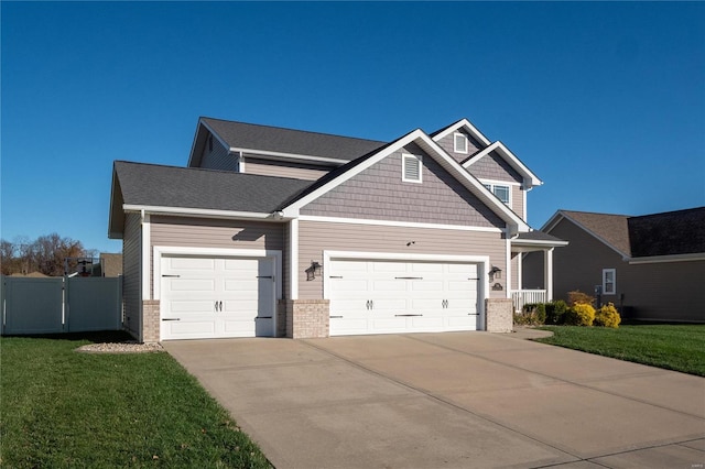 craftsman-style home featuring a front lawn and a garage