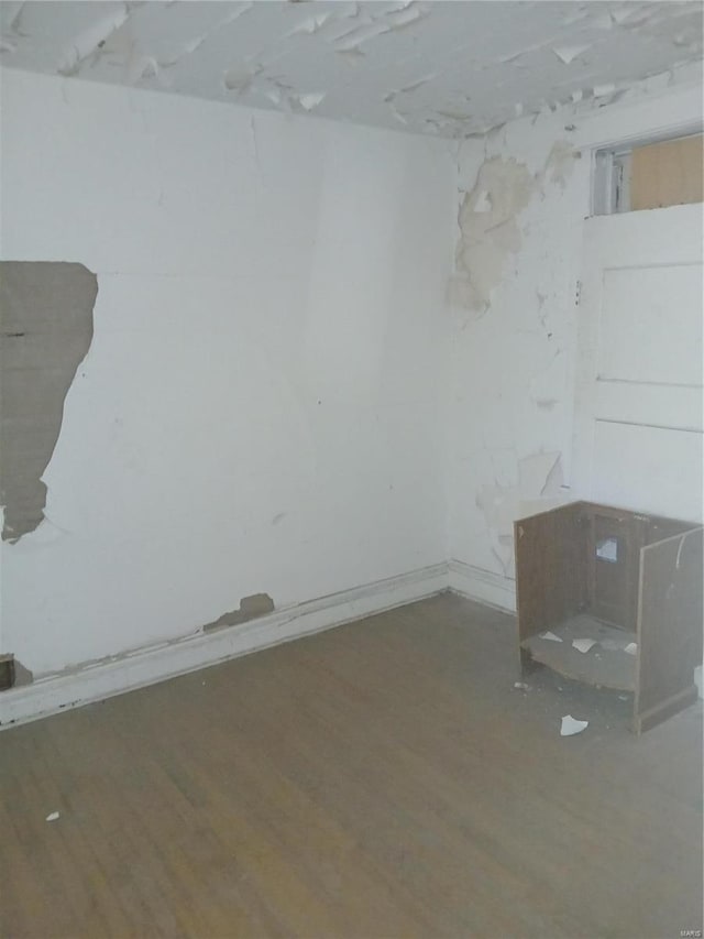 unfurnished room with hardwood / wood-style floors