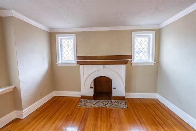 unfurnished living room with wood-type flooring, a textured ceiling, and a wealth of natural light