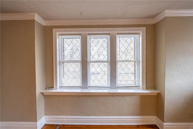 room details with ornamental molding and a textured ceiling