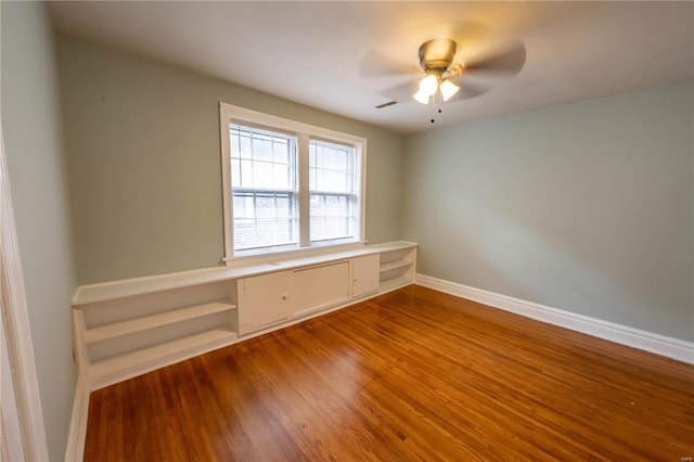 unfurnished room with wood-type flooring and ceiling fan