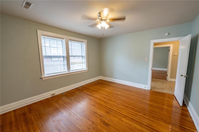 unfurnished room featuring ceiling fan and light hardwood / wood-style flooring