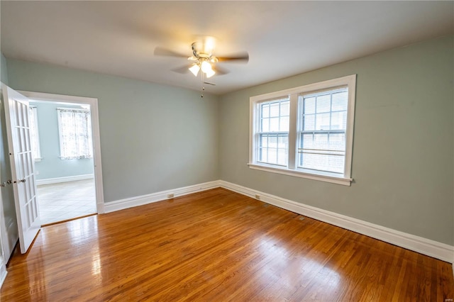 empty room with ceiling fan, light hardwood / wood-style floors, and a wealth of natural light