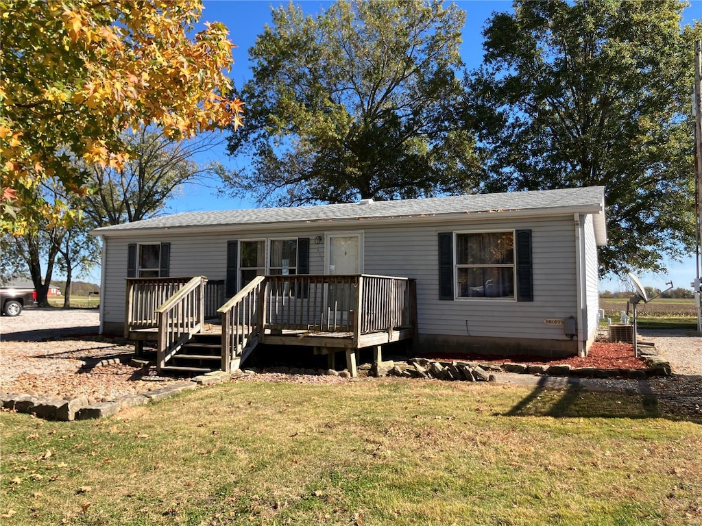 manufactured / mobile home featuring a front yard and a deck