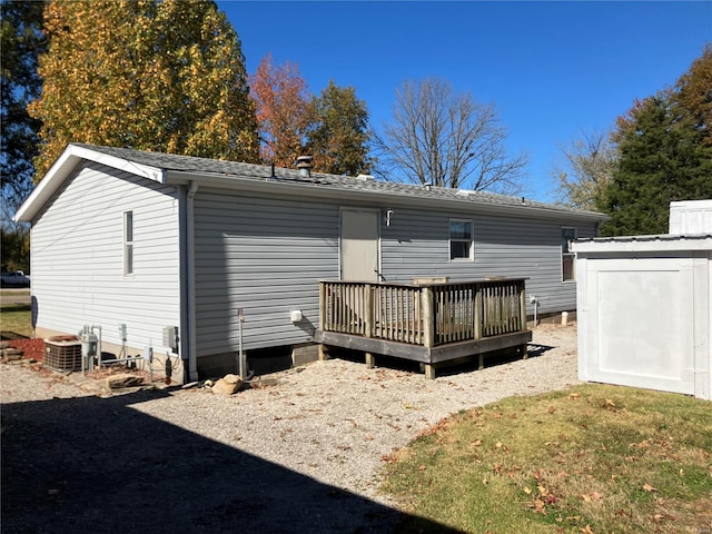 back of house featuring a deck and central AC