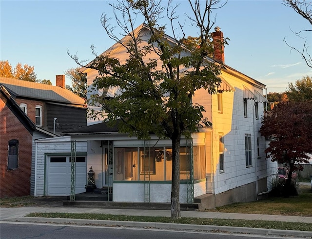 view of front of property with a garage and a chimney