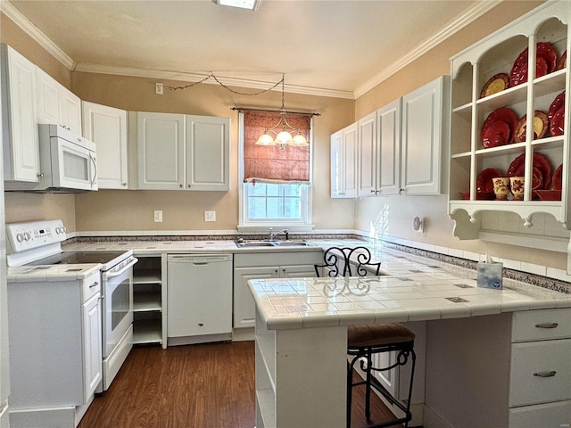 kitchen with a breakfast bar, open shelves, white cabinets, white appliances, and a peninsula