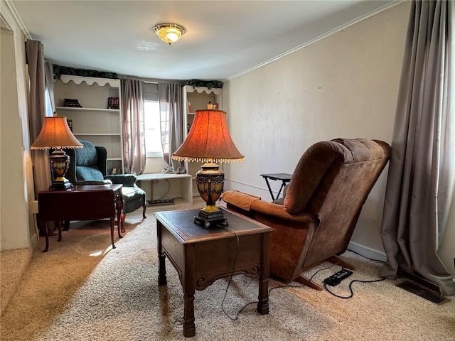 sitting room with carpet floors and ornamental molding