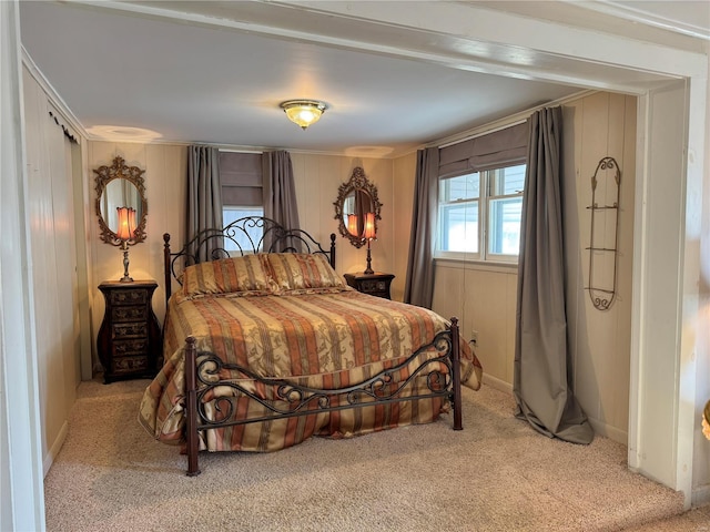 bedroom with light carpet and baseboards