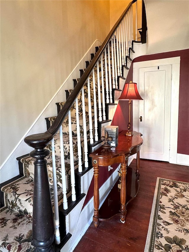 stairs featuring baseboards and wood finished floors