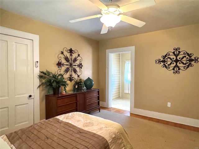 bedroom with wood finished floors, a ceiling fan, and baseboards