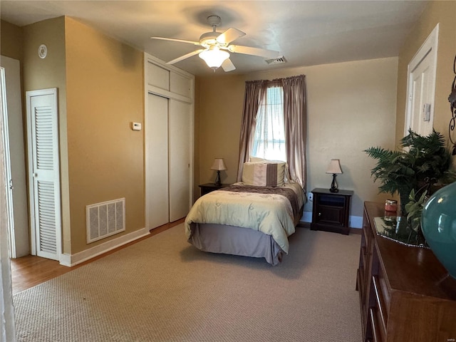 bedroom with carpet floors, a ceiling fan, visible vents, and baseboards