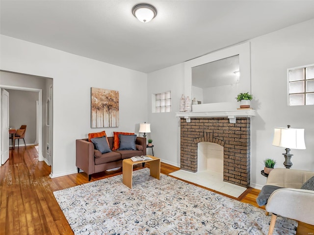 living room with wood-type flooring and a fireplace