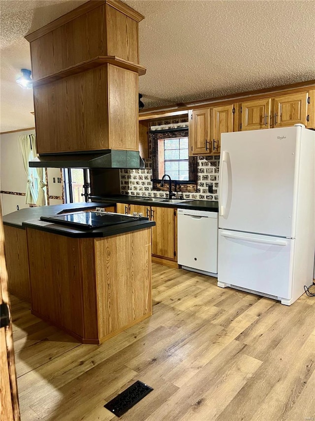 kitchen featuring light hardwood / wood-style flooring, a textured ceiling, sink, and white appliances