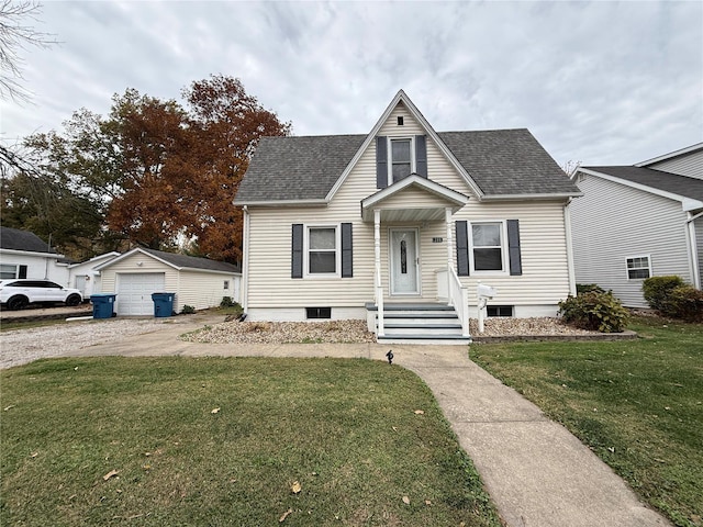 view of front facade with an outbuilding, a garage, and a front yard