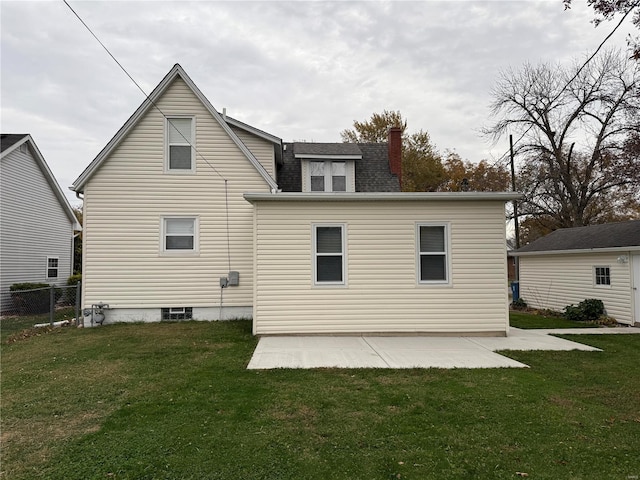 back of house with a patio and a yard