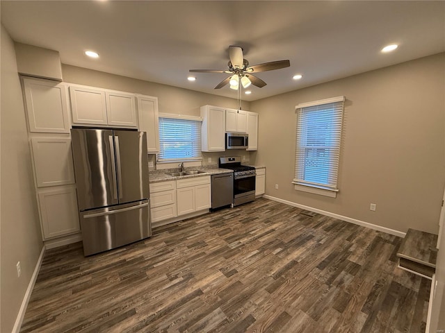 kitchen featuring stainless steel appliances, white cabinets, sink, dark hardwood / wood-style floors, and ceiling fan