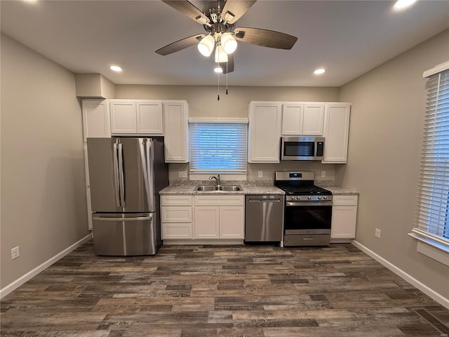 kitchen with white cabinetry, appliances with stainless steel finishes, dark wood-type flooring, and sink