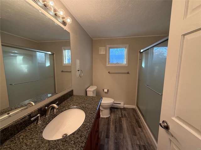 bathroom with walk in shower, baseboard heating, wood-type flooring, and a healthy amount of sunlight