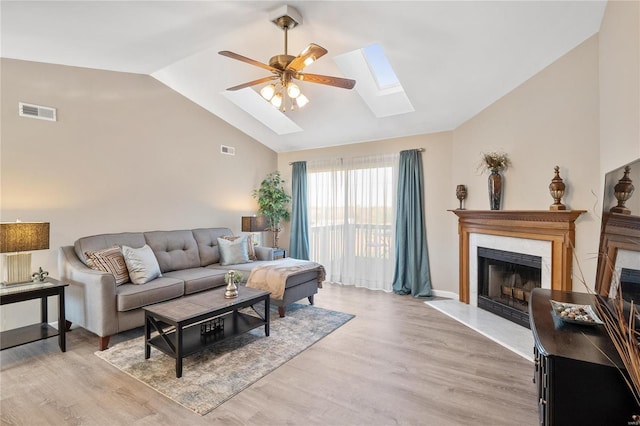 living room featuring light wood-type flooring, lofted ceiling, and ceiling fan