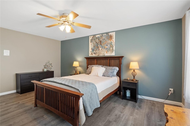 bedroom with dark hardwood / wood-style flooring and ceiling fan