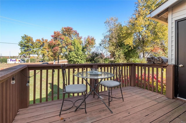 wooden terrace featuring a yard