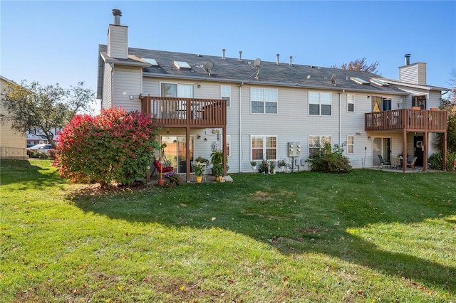 back of house featuring a yard and a deck