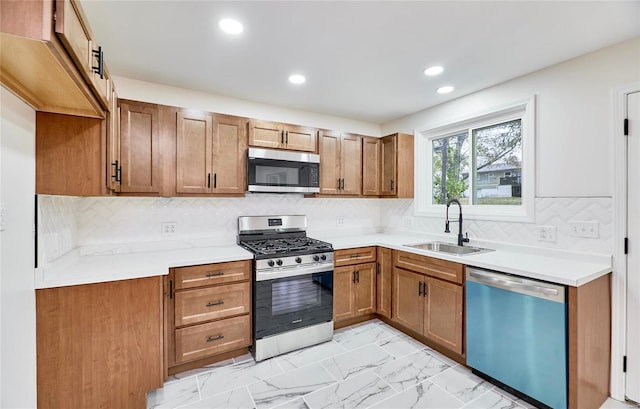 kitchen with stainless steel appliances, sink, and decorative backsplash