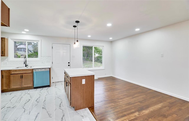 kitchen with pendant lighting, sink, dishwasher, a center island, and decorative backsplash